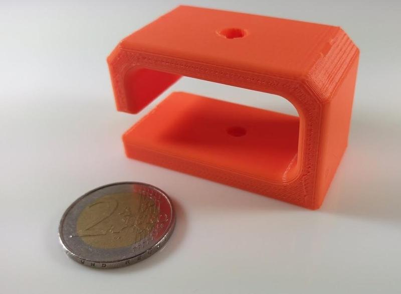 Cable holder for the underside of the desk