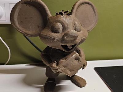 A cute mouse holding cheese