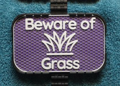 Beware of Grass sign