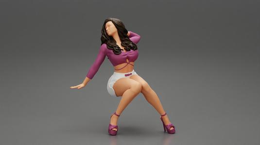 Young sexy girl in shorts with long hair is sitting with one hand in hair