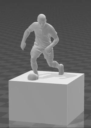 a figurine of a football player on a pedestal   