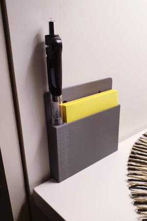 Stand on the wall for a pad with a pen.