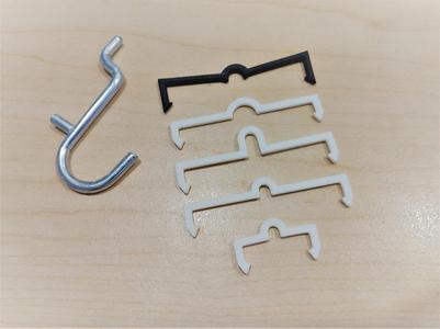Tight-fitting pegboard clip