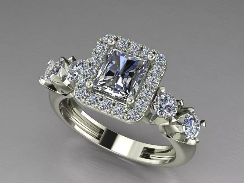 A HALO EMERALD  CUT  RING  WEEDING AND ENGAGEMENT RING