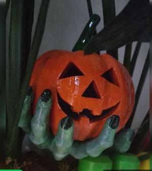 A pumpkin in a Zombie hand