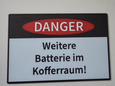 Warning sign auxiliary battery in trunk