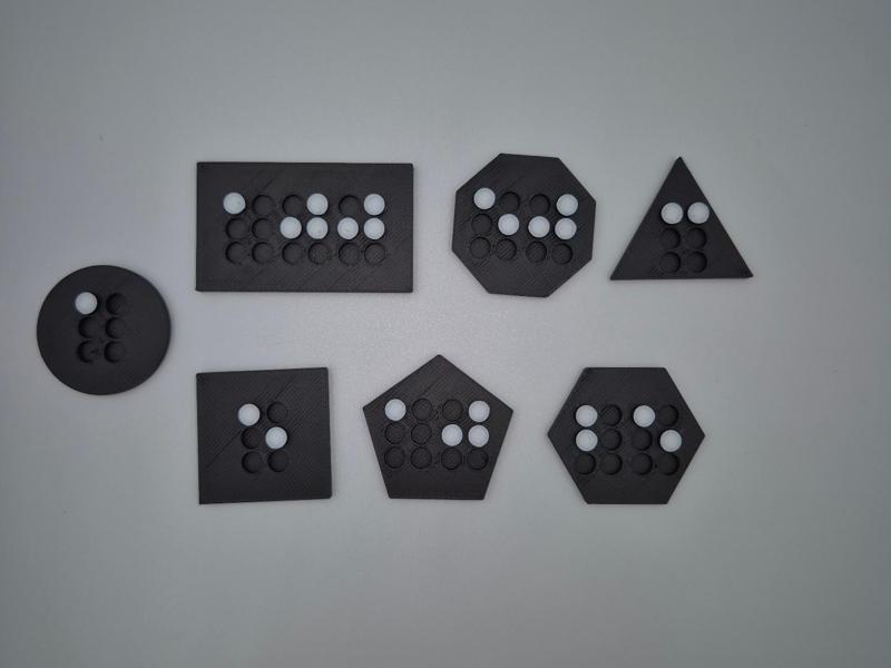 Braille game token for visually impaired people
