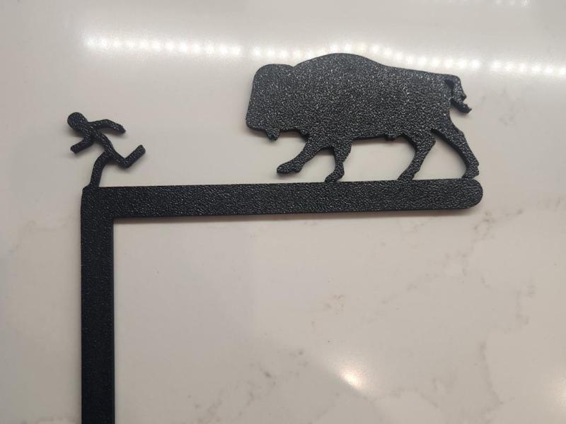 Bison chasing person sign