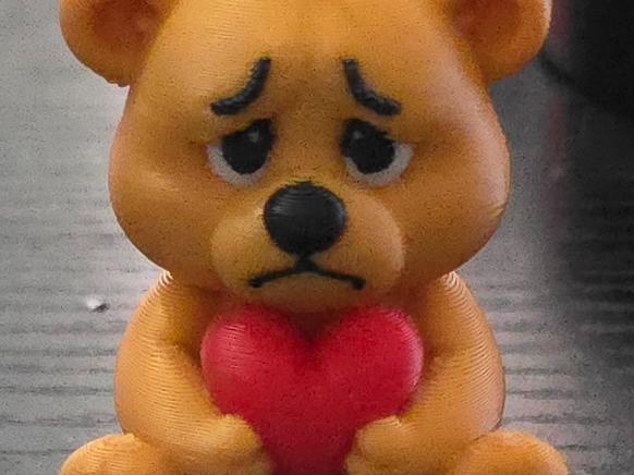 Cute sad teddy bear with hart 