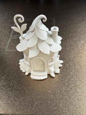 A house in a tree stump with a leafy roof   