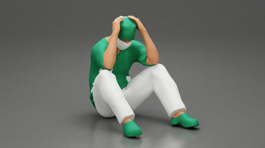 Thoughtful Surgeon Sitting  With His Hand On Head