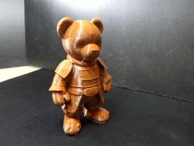 A cute terra cotta teddy bear.   