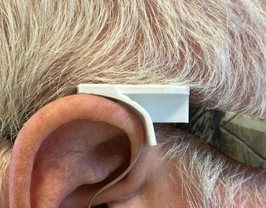 Hearing aid wind deflector 