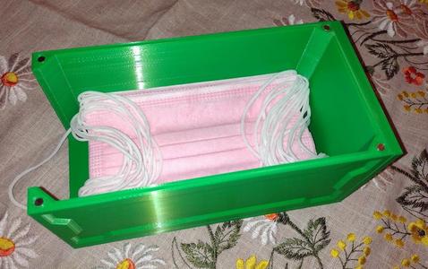 Container for medical masks with a magnetic lid