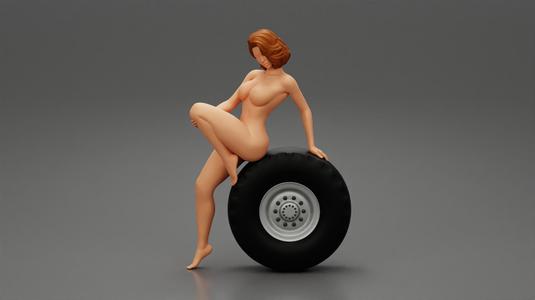 Sexy naked girl sitting on a truck tyre