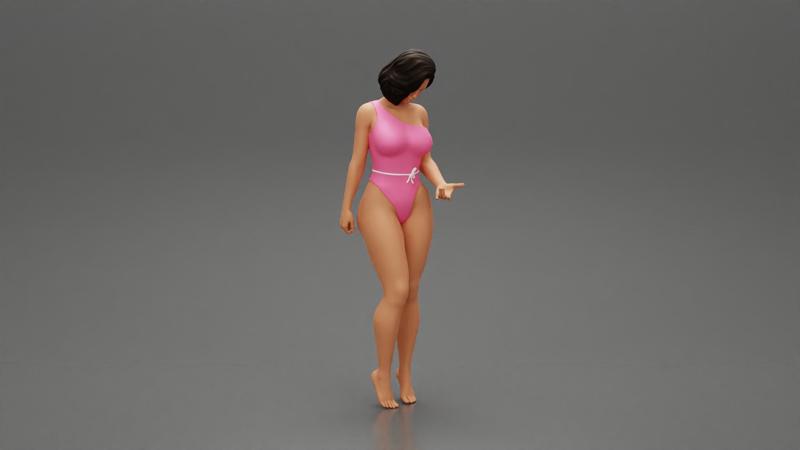 Beautiful girl in onepiece bikini standing on the beach