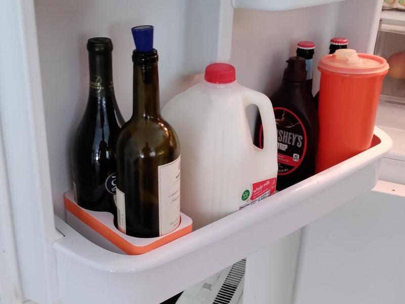 Wine holder for fridge door shelf