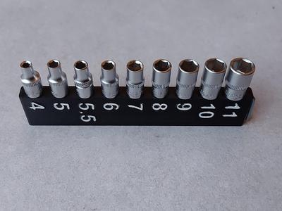 Modular ratchet socket holder for 1/4" square sockets. Replaceable springs.