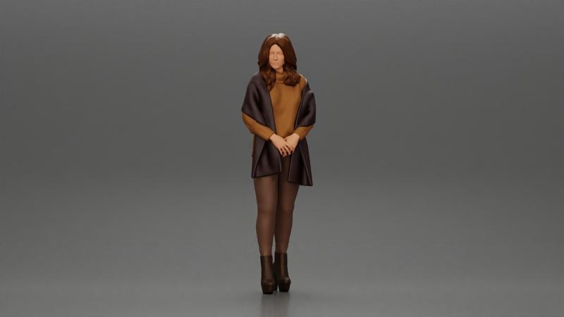 woman in the cold standing wearing a shawl and heels