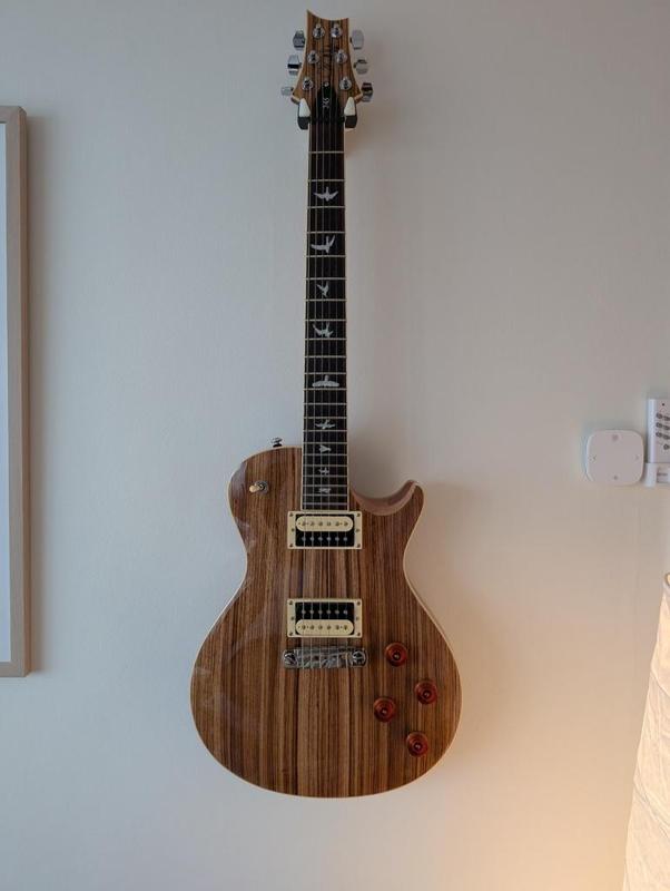 Pivoting guitar wall hanger