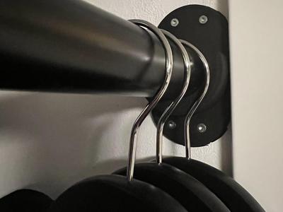 Wall-to-pipe attachment for hanging clothes.