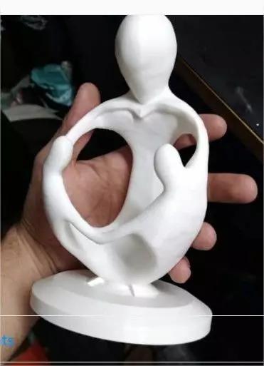 pendant person holding sculpture