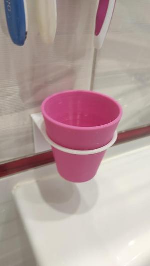Glass with wall holder for the bathroom