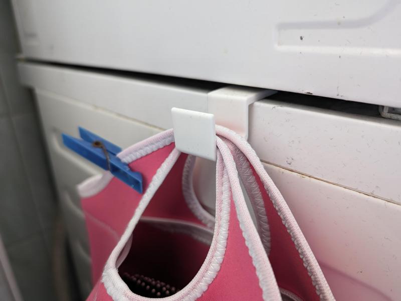 Hanger between washer and dryer