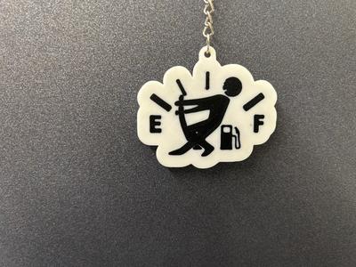 Keychain little man lifting gas pump nozzle