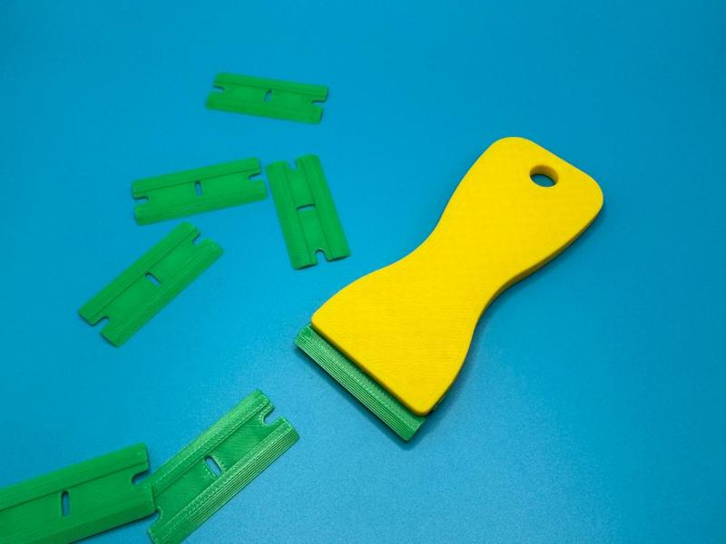 Scraper with replaceable blades