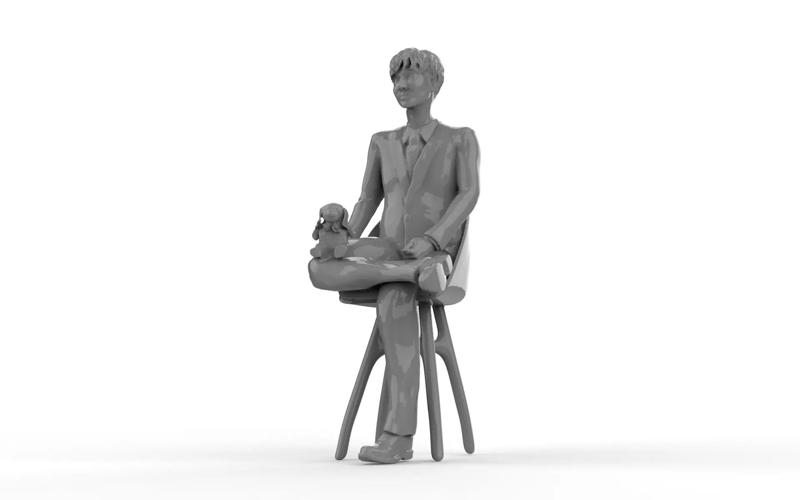 Artist sitting on chair with teddy