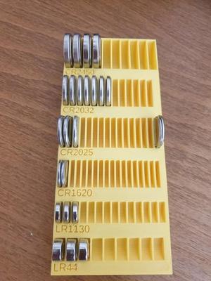 Button battery plate