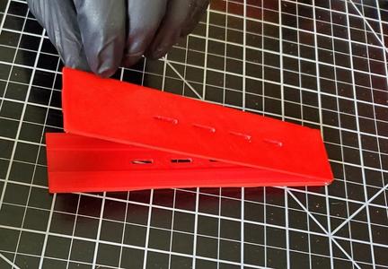 Jig to make button holes in 1/2" elastic for use with face shields