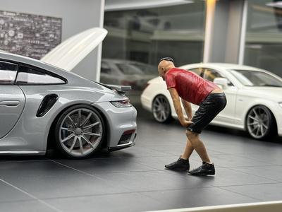 A short sleeved boy bending over to observe