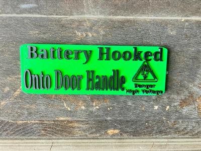 Battery on Door Handle Sign