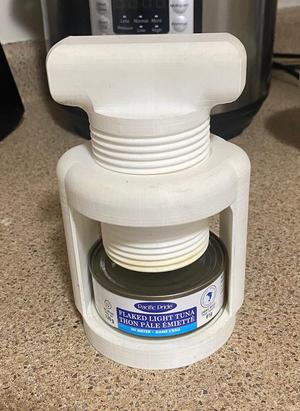 Tuna can squeezer