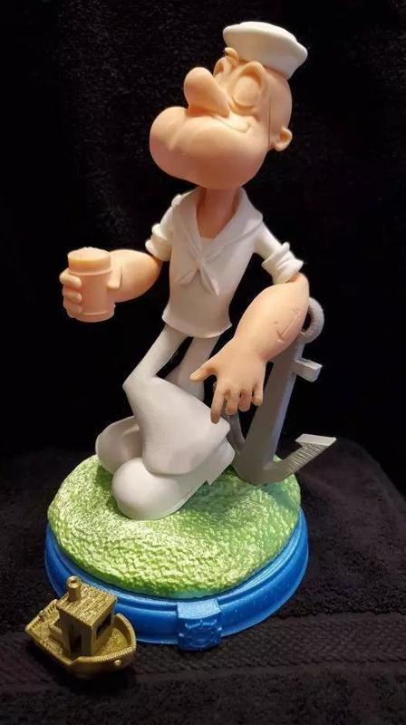 Popeye figurine of sailor holding cup