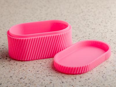 Ribbed oval box with lid.