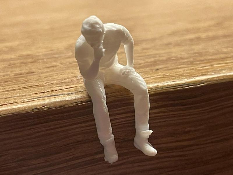 Small seated, pensive man