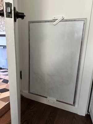 White board behind door storage holder