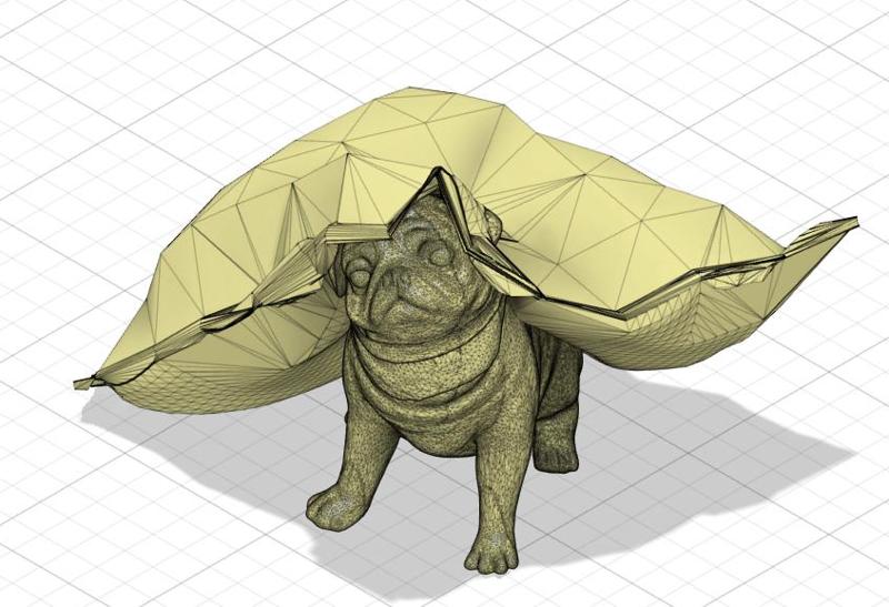 Pug peeking out a cushion