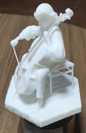 Elegant Cellist Playing: Decorative Figurine   