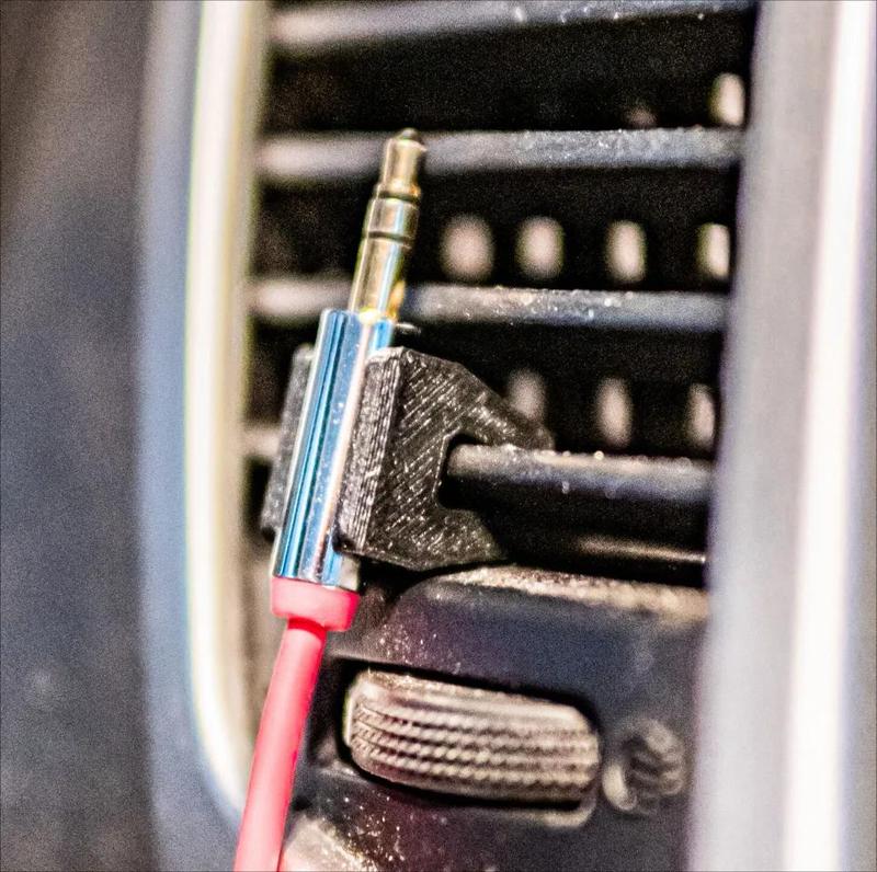 Car air vent headphone cord holder   