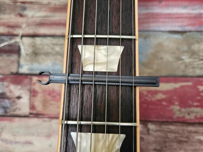 Guitar and bass capo for electric and acoustic instruments