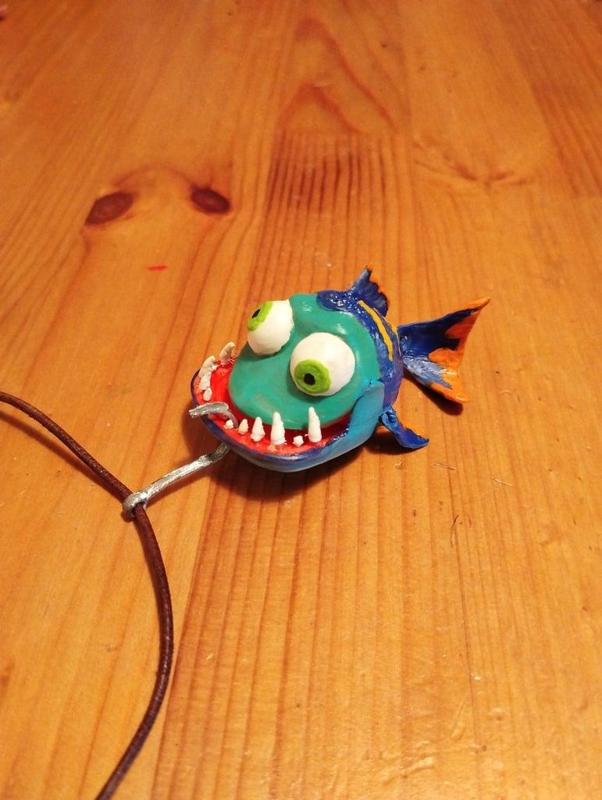 Fish on hook necklace with articulated fins