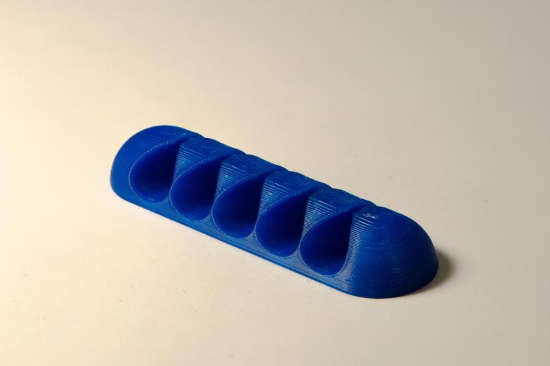 Asymmetric cable holder