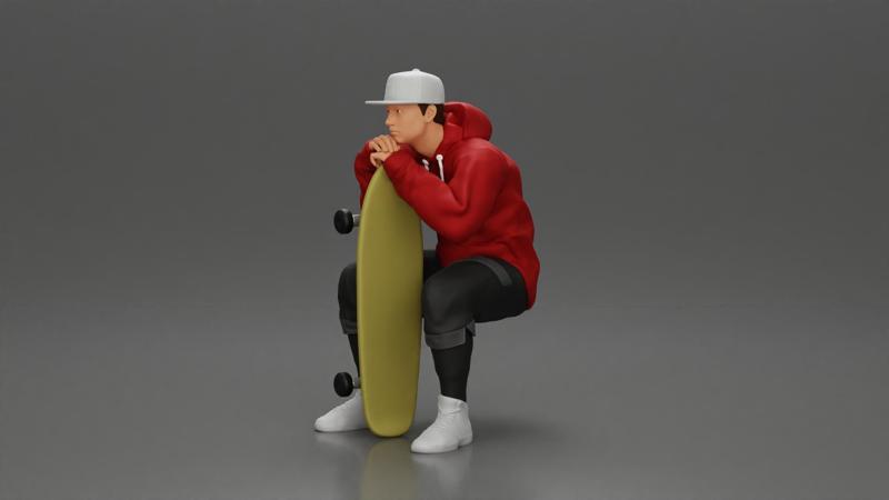 man in hoodie and cap sitting and putting his hand on the skateboard