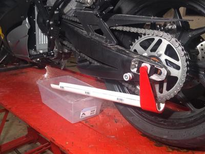 Motorcycle chain lube drain