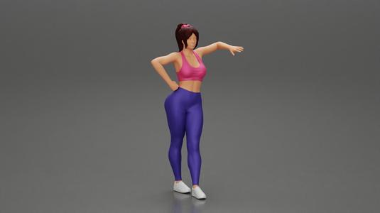 Sexy fitness girl leaning on a wall while standing outdoors