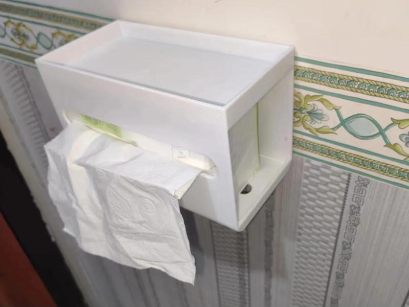 Double-sided tissue box that can hold a phone